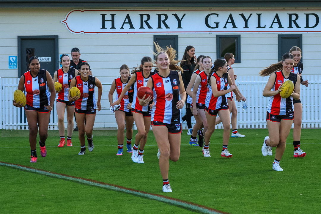 Ainslie's Under 18 Women running out to play Belconnen on Friday Night, with grins ear to ear!